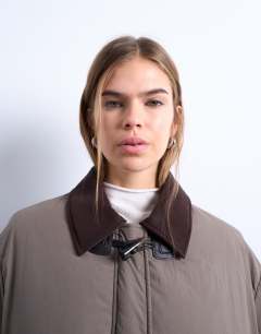 Model wearing Nylon padded car coat with contrast suedette collar in khaki