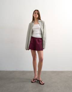 Model wearing Nylon runner short with insert ties