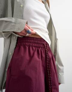 Model wearing Nylon runner short with insert ties