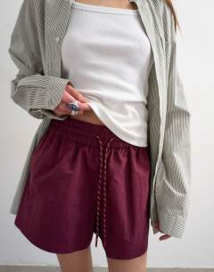 Model wearing Nylon runner short with insert ties