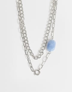 Model wearing Oakley stainless steel multi chain necklace with blue stone in silver