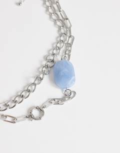 Model wearing Oakley stainless steel multi chain necklace with blue stone in silver
