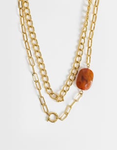 Model wearing Oakley stainless steel multi chain necklace with orange stone in gold
