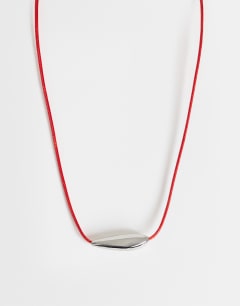 Model wearing Octavia collar length necklace in red with silver detail