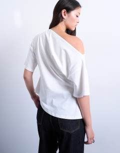 Model wearing Off shoulder asymmetric top with cinch detail in ivory