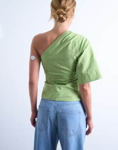 Model wearing Off shoulder drape neck in avocado green