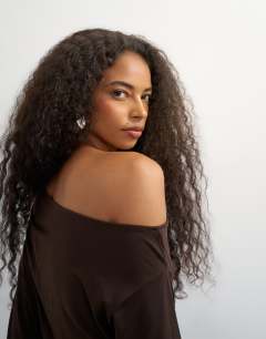 Model wearing Off shoulder long sleeve top in deep mahogany
