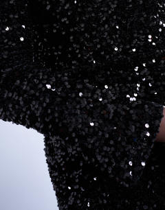 Model wearing Off shoulder mini sequin velvet dress in black