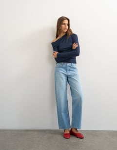 Model wearing Off shoulder ruched long sleeve top in navy