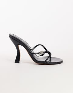 Model wearing Olivia strappy high heel sandal with ball detail in black