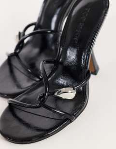 Model wearing Olivia strappy high heel sandal with ball detail in black