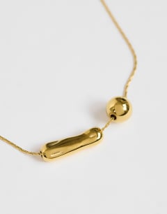 Model wearing Olivio stainless steel necklace in gold