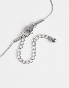 Model wearing Olivio stainless steel necklace in silver with blue bead