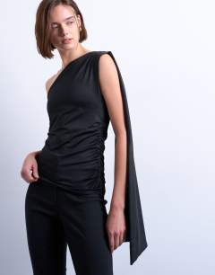 Model wearing One shoulder cape detail top in black