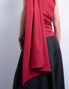Model wearing One shoulder cape detail top in red