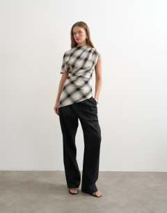 Model wearing One sleeve slash neck top in check print