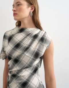 Model wearing One sleeve slash neck top in check print