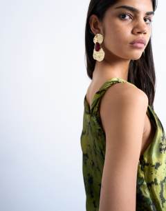 Model wearing One sleeve twist strap satin maxi dress in green floral