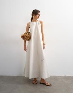 Model wearing Open back buckle strap chuck on maxi dress in off white