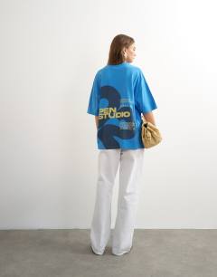 Model wearing Topshop 'Open Studio' oversized graphic t-shirt in blue