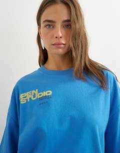 Model wearing Topshop 'Open Studio' oversized graphic t-shirt in blue