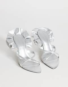 Model wearing Ophelia real leather high heeled sandal with ruffle in silver