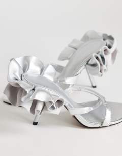 Model wearing Ophelia real leather high heeled sandal with ruffle in silver