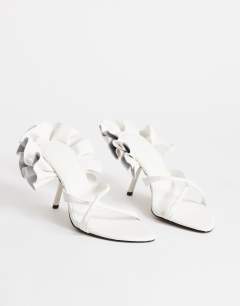 Model wearing Ophelia real leather high heeled sandal with ruffle in white