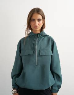 Model wearing Organza bomber in teal