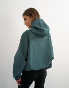 Model wearing Organza bomber in teal