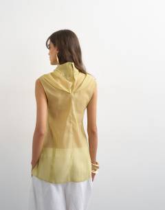 Model wearing Organza collapsed funnel neck top in muted lime