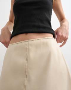 Model wearing Organza column maxi skirt with contrast stitching in oyster