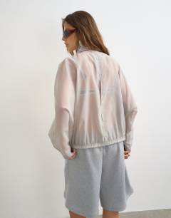 Model wearing Organza funnel neck bomber with contrast binding in grey
