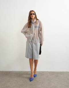 Model wearing Organza funnel neck bomber with contrast binding in grey