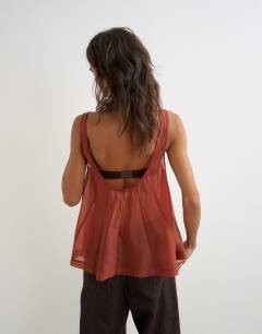 Model wearing Organza sheer sleeveless pintuck cami in rust