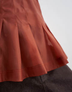 Model wearing Organza sheer sleeveless pintuck cami in rust