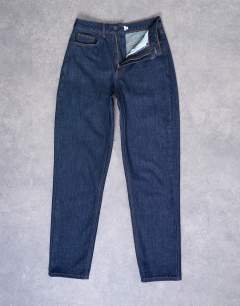 Model wearing Original Mom high rise jean in indigo rinse