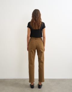 Model wearing Orson comfort stretch straight leg ankle grazer jean in cumin