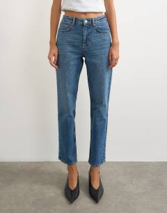 Model wearing Orson comfort stretch straight leg ankle grazer jean in mid blue