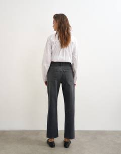 Model wearing Orson comfort stretch straight leg ankle grazer jean in washed black