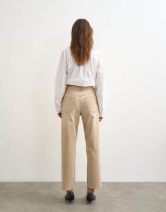 Model wearing Orson comfort stretch straight leg ankle grazer jean in winter oat
