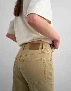 Model wearing Orson mid rise comfort straight jean in dark beige