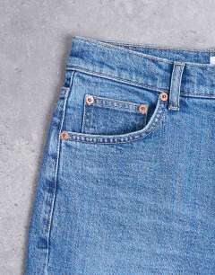 Model wearing Orson mid rise comfort straight jean in mid blue