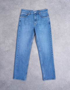 Model wearing Orson mid rise comfort straight jean in mid blue