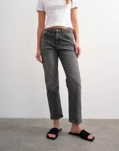 Model wearing Orson mid rise comfort straight jean in washed grey