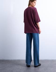 Model wearing Oslo graphic tee in burgundy