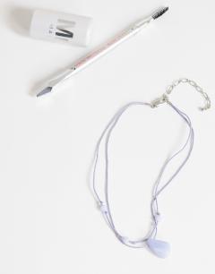 Model wearing Ottie cord necklace with semi precious stones in light blue