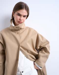 Model wearing Oversized clean funnel neck trench coat in beige