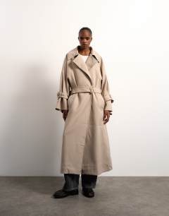 Model wearing Oversized clean tailored Trench with dropped armhole in stone