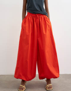 Model wearing Oversized cuff balloon trouser in red